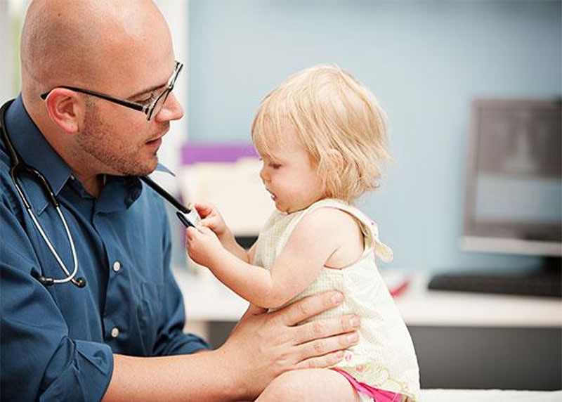 Paediatrician holds baby girl