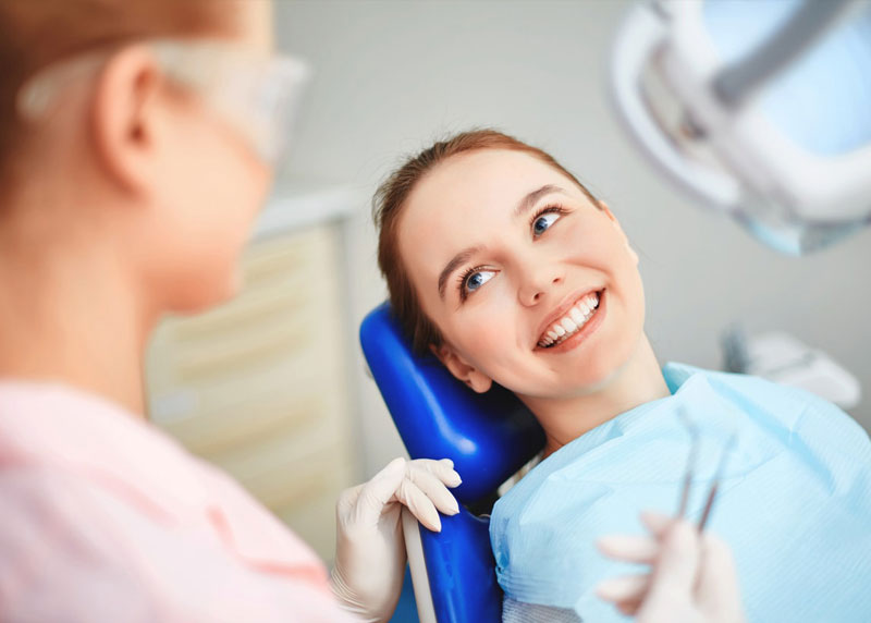 young woman smiles dentist